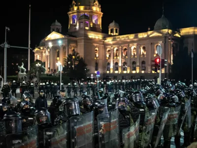 Law enforcement officers in riot gear stand guard as they separate anti-government protesters and supporters of Serbian President Aleksandar Vucic, near the parliament building in Belgrade, Serbia, November 2, 2025. REUTERS/Marko Djurica