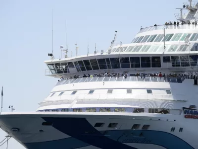 A cruise ship carrying Israeli tourists try to approach the Aegean Sea island of Syros, Greece, Tuesday, July 22, 2025. (Nikos Panagiotopoulos/InTime News via AP)