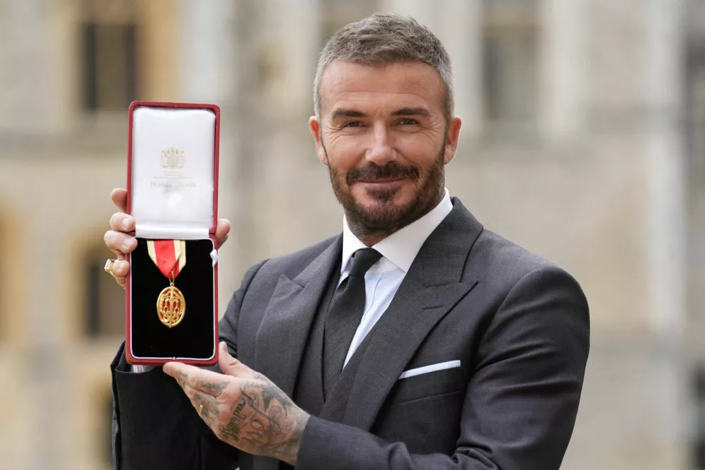 Sir David Beckham stands after he was made a Knight Bachelor at an investiture ceremony at Windsor Castle, Berkshire. November 4, 2025. Andrew Matthews/Pool via REUTERS