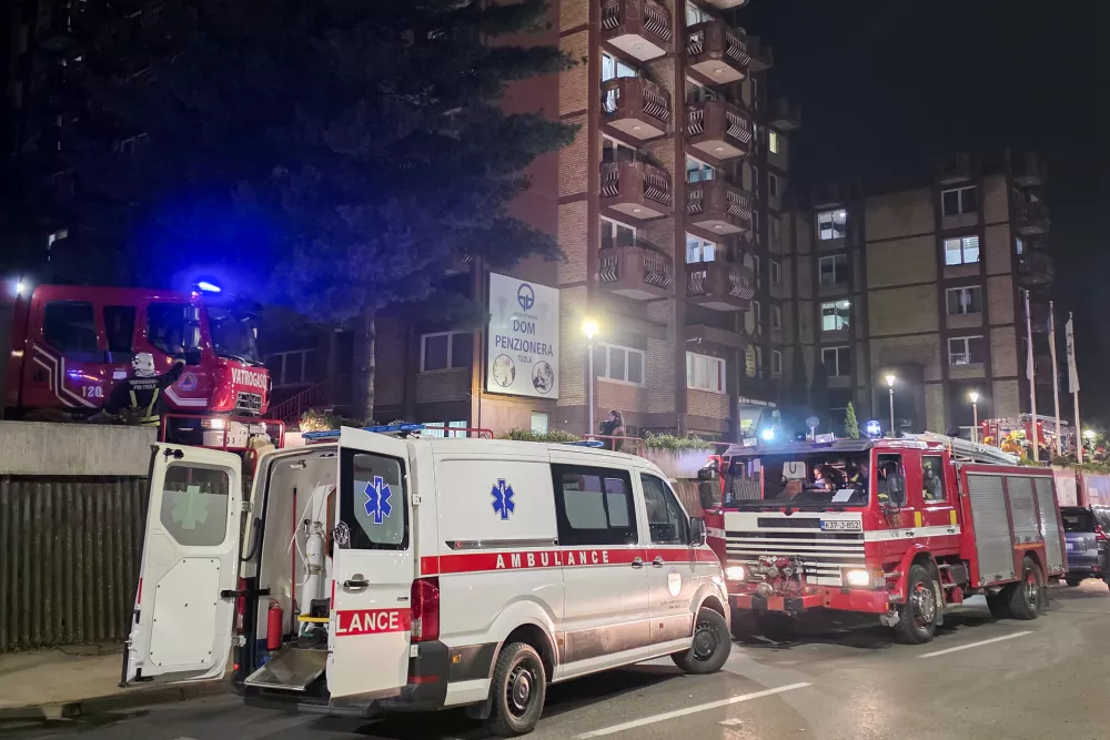 A rescue cars are parked in front of a nursing home after a fire in Tuzla, Bosnia, Tuesday, Nov. 4, 2025. (AP Photo)