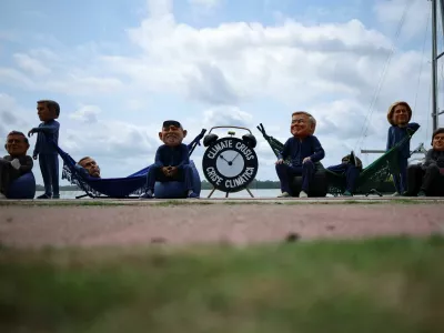 Oxfam activists wearing big head masks depicting world leaders stage a "Sleeping on the Job" protest to criticize the inadequacy of decisions made by the world's largest economies in combating the climate crisis, ahead of the United Nations Climate Change Conference COP30 in Belem, Brazil, November 5, 2025. REUTERS/Adriano Machado   TPX IMAGES OF THE DAY