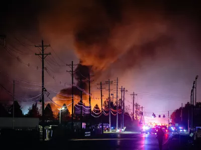 Plums of smoke rise from the area of a UPS cargo plane crash at Louisville Muhammad Ali International Airport, on Tuesday, Nov. 4, 2025, in Louisville, Ky. (AP Photo/Jon Cherry)
