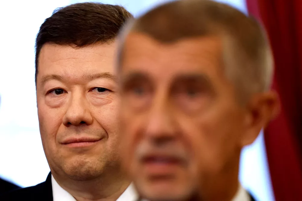 FILE PHOTO: Leader of Freedom and Direct Democracy (SPD) party Tomio Okamura stands behind leader of ANO party Andrej Babis after signing a coalition agreement at the Czech Parliament in Prague, Czech Republic, November 3, 2025. REUTERS/David W Cerny/File Photo
