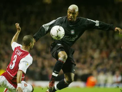 Arsenal's Ashley Cole, left, challenges Liverpool's El-Hadji Diouf during their FA Premier League soccer match at Arsenal's Highbury ground in London Sunday, Dec. 29, 2002. (AP Photo/Alastair Grant)