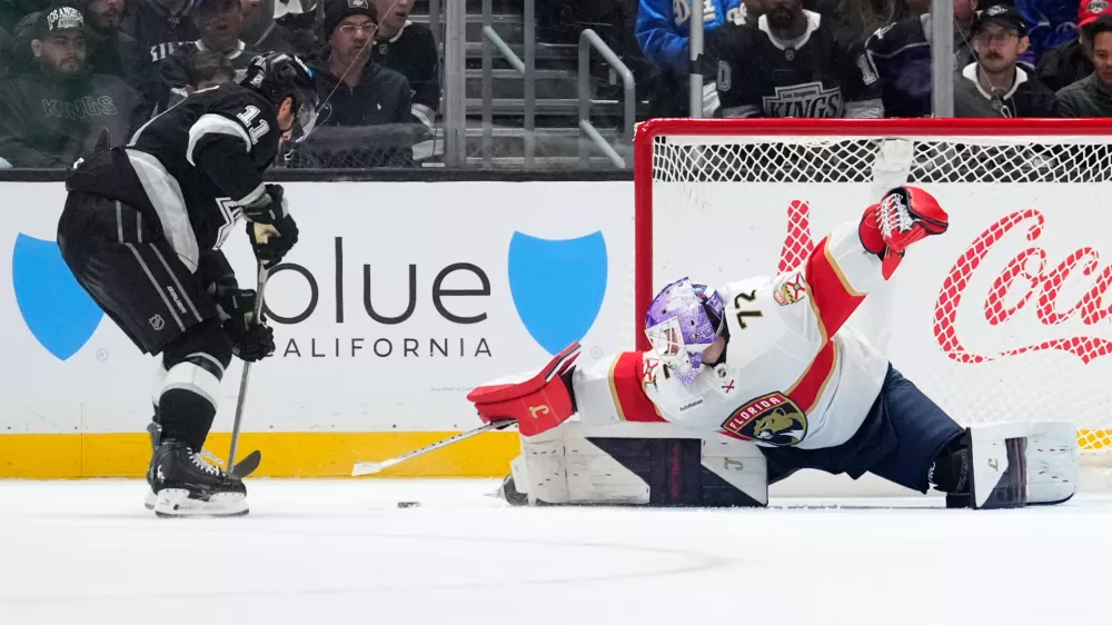 Florida Panthers goaltender Sergei Bobrovsky, right, stops a shot by Los Angeles Kings center Anze Kopitar during the third period of an NHL hockey game Thursday, Nov. 6, 2025, in Los Angeles. (AP Photo/Mark J. Terrill)