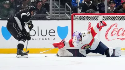 Florida Panthers goaltender Sergei Bobrovsky, right, stops a shot by Los Angeles Kings center Anze Kopitar during the third period of an NHL hockey game Thursday, Nov. 6, 2025, in Los Angeles. (AP Photo/Mark J. Terrill)