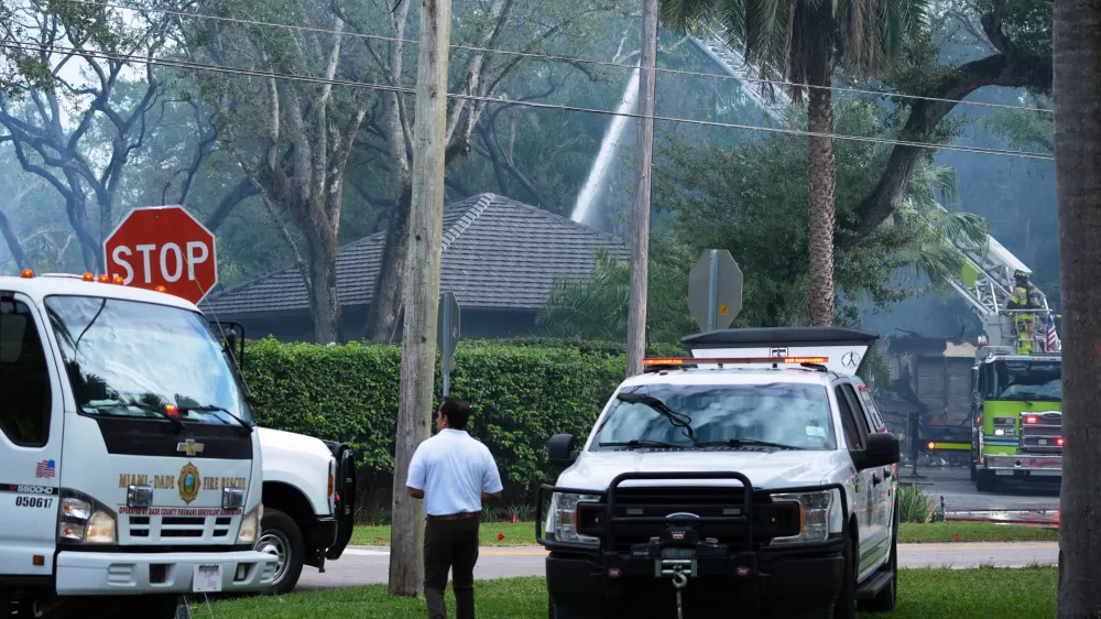Firefighters work to extinguish the remains of a fire at a home owned by Miami Heat basketball coach Erik Spoelstra, Thursday, Nov. 6, 2025, in Miami. (AP Photo/Rebecca Blackwell)