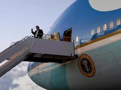 FILE PHOTO: U.S. President Donald Trump pumps a fist as he disembarks Air Force One at Palm Beach International Airport, West Palm Beach, Florida, U.S., April 11, 2025. REUTERS/Nathan Howard/File Photo