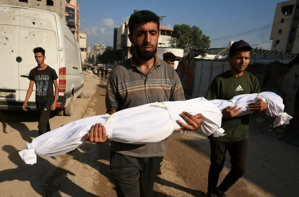 Mourners carry the shrouded bodies of Palestinian sisters Layan Salem, 2, and Eman Salem, 5, who were killed in an overnight Israeli strike on a tent, according to medics, during their funeral in Gaza City, September 8, 2025. REUTERS/Dawoud Abu Alkas