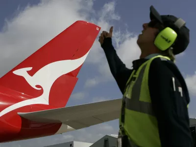 ﻿A worker gives his thumb up to a Qantas Airbus A380 as it arrives at a hangar after it landed at Kingsford Smith International Airport in Sydney September 21, 2008. Qantas took delivery of its first A380 superjumbo on Friday, two years later than planned due to production delays, and Airbus denied it planned another cut in its 2008 delivery forecast from the current 12 aircraft.  REUTERS/Daniel Munoz (AUSTRALIA) - RTX8R5U