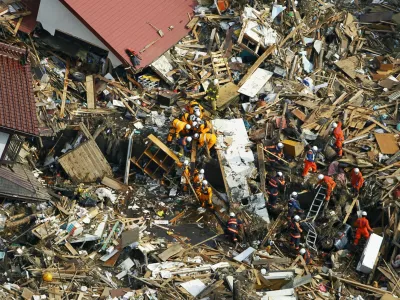 Rescuers searches for the victims of Friday's tsunami at Noda village, Iwate Prefecture, northern Japan, Monday, March 14, 2011, three days after a massive earthquake and the ensuing tsunami hit the country's east coast. (AP Photo/Kyodo News) JAPAN OUT, MANDATORY CREDIT, NO LICENSING IN CHINA, HONG KONG, JAPAN, SOUTH KOREA AND FRANCE