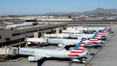 American Airlines jets sit parked at their jetways at Phoenix Sky Harbor International Airport Saturday, Nov. 8, 2025, in Phoenix. (AP Photo/Ross D. Franklin)