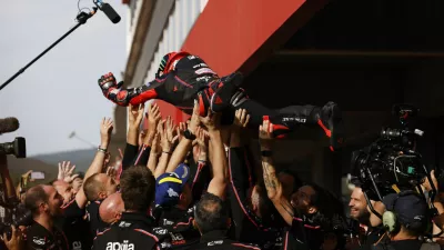 MotoGP - Portuguese Grand Prix - Algarve International Circuit, Portimao, Portugal - November 9, 2025 Aprilia Racing's Marco Bezzecchi celebrates with team after winning the MotoGP race REUTERS/Marcelo Del Pozo