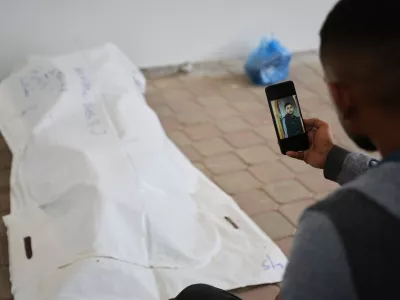 A relative shows a photo of Rami Assaf after his body was identified by his family. His remains were returned from Israel as part of the cease-fire deal and brought to Nasser Hospital in Khan Younis, Gaza Strip, Saturday, Nov. 8, 2025. (AP Photo/Abdel Kareem Hana)