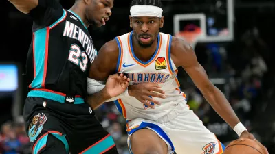 Oklahoma City Thunder guard Shai Gilgeous-Alexander, right, handles the ball against Memphis Grizzlies forward Cedric Coward (23) in the second half of an NBA basketball game Sunday, Nov. 9, 2025, in Memphis, Tenn. (AP Photo/Brandon Dill)