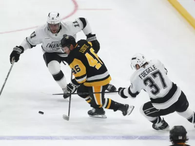Nov 9, 2025; Pittsburgh, Pennsylvania, USA; Los Angeles Kings center Anze Kopitar (11) and left wing Warren Foegele (37) defend Pittsburgh Penguins center Blake Lizotte (46) during the third period at PPG Paints Arena. Mandatory Credit: Charles LeClaire-Imagn Images