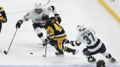 Nov 9, 2025; Pittsburgh, Pennsylvania, USA; Los Angeles Kings center Anze Kopitar (11) and left wing Warren Foegele (37) defend Pittsburgh Penguins center Blake Lizotte (46) during the third period at PPG Paints Arena. Mandatory Credit: Charles LeClaire-Imagn Images