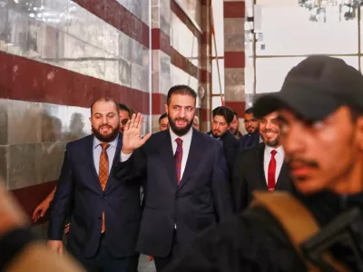 FILE - Syrian interim President Ahmad al-Sharaa waves as he enters a polling station where electoral college members are voting in a parliamentary election in Damascus, Syria, Oct. 5, 2025. (AP Photo/Omar Sanadiki, File)