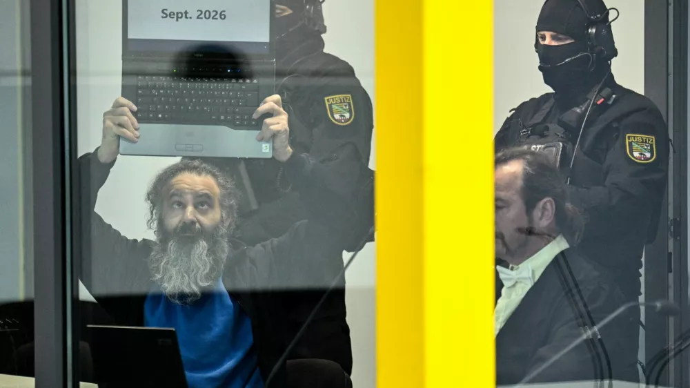 Suspect Taleb al-Abdulmohsen, a 51-year-old doctor from Saudi Arabia, who faces charges of murder, attempted murder and dangerous interference with road traffic, shows a laptop with the text "Sept. 2026", at the opening of his trial for the Magdeburg Christmas market attack, at a regional court in Magdeburg, Germany, November 10, 2025. REUTERS/Annegret Hilse