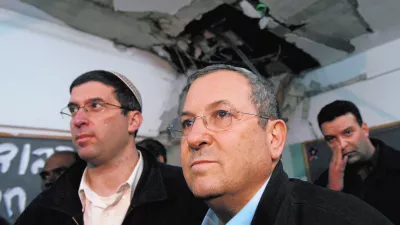 Israel's Defence Minister Ehud Barak (C) surveys a damaged classroom after a rocket landed in a school in the southern city of Beersheba December 31, 2008. Israel on Wednesday said the time was not right for a ceasefire in the Gaza Strip and stepped up preparations for a possible ground offensive after Hamas's long-range rockets hit another major population centre. At least four of the longer-range Grad rockets hit Beersheba, the city Israel calls the capital of the Negev, its southern region. One struck the school that was empty. REUTERS/Gil Cohen Magen (ISRAEL)------4 kolone