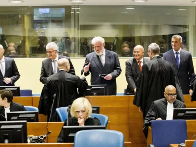 ﻿Back row from left: Bosnian Croats Jadranko Prlic, Bruno Stojic, Slobodan Praljak, Milivoj Petkovic, Valentin Coric and Berislav Pusic prior to their judgment at the Yugoslav war crimes tribunal (ICTY) in The Hague, Netherlands, Wednesday May 29, 2013. The ICTY delivers verdicts in the long-running trial of six senior Bosnian Croats on charges of crimes against Muslims and Serbs as they tried to carve out a Croat state in Bosnia during the country's 1992-95 war. Prosecutors have asked for sentences of up to 40 years for the suspects. (AP Photo/Jiri Buller, Pool)
