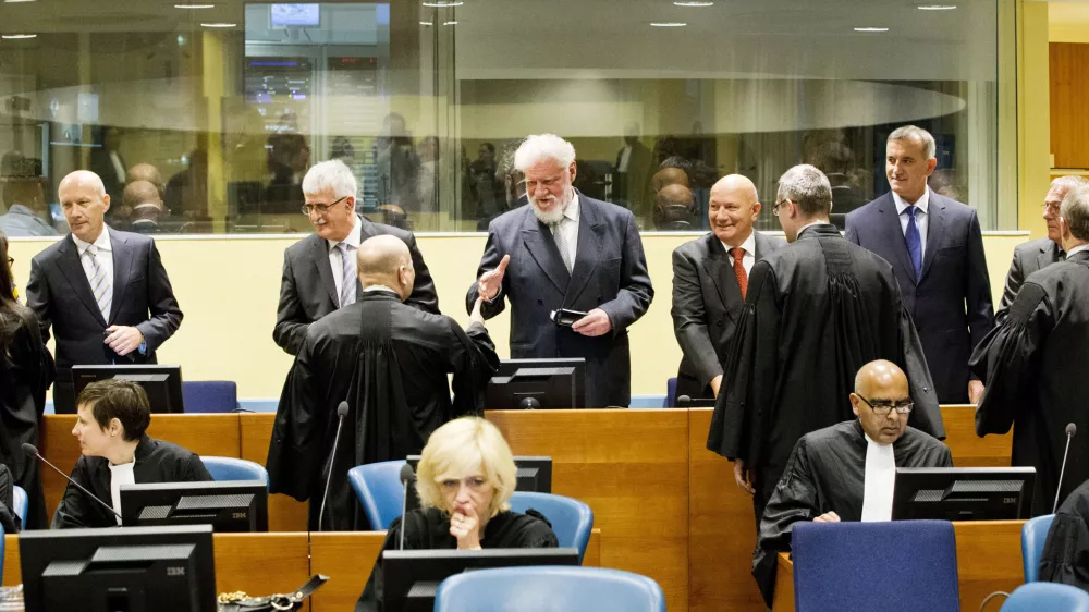 ﻿Back row from left: Bosnian Croats Jadranko Prlic, Bruno Stojic, Slobodan Praljak, Milivoj Petkovic, Valentin Coric and Berislav Pusic prior to their judgment at the Yugoslav war crimes tribunal (ICTY) in The Hague, Netherlands, Wednesday May 29, 2013. The ICTY delivers verdicts in the long-running trial of six senior Bosnian Croats on charges of crimes against Muslims and Serbs as they tried to carve out a Croat state in Bosnia during the country's 1992-95 war. Prosecutors have asked for sentences of up to 40 years for the suspects. (AP Photo/Jiri Buller, Pool)