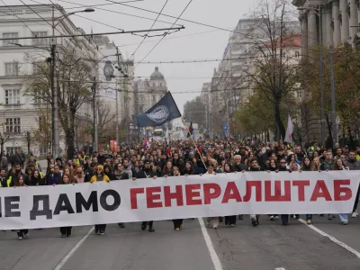 People hold a banner that reads: "We do not give army headquarters" during a protest in front of military complex that was partially destroyed in a NATO bombing campaign in 1999, after Serbian lawmakers on Friday passed a special law clearing the way for a controversial real estate project that would be financed by an investment company linked to President Trump's son-in-law Jared Kushner, in Belgrade, Serbia, Tuesday, Nov. 11, 2025. (AP Photo/Darko Vojinovic)