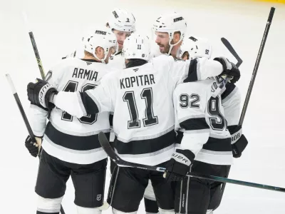 Los Angeles Kings' Joel Edmundson (6) celebrates his goal over Montreal Canadiens with teammates Brandt Clarke (92), Anze Kopitar (11), Joel Armia (40) and Adrian Kempe (9) during second period NHL hockey action in Montreal on Tuesday, Nov. 11, 2025. (Christinne Muschi/The Canadian Press via AP)