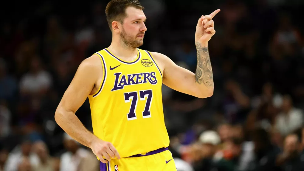 Oct 14, 2025; Phoenix, Arizona, USA; Los Angeles Lakers guard Luka Doncic (77) reacts against the Phoenix Suns during an NBA preseason game at Mortgage Matchup Center. Mandatory Credit: Mark J. Rebilas-Imagn Images