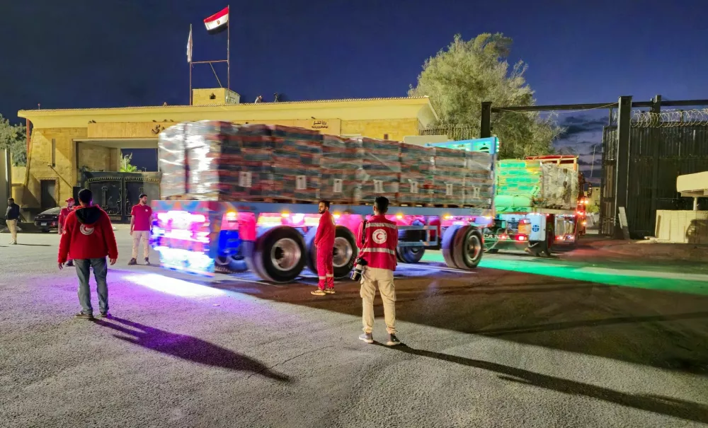 FILE PHOTO: Trucks carrying aid bound for Gaza cross the border crossing between Egypt and the Gaza Strip, after a ceasefire between Israel and Hamas in Gaza went into effect, in Rafah, Egypt, October 12, 2025. REUTERS/Stringer/File Photo