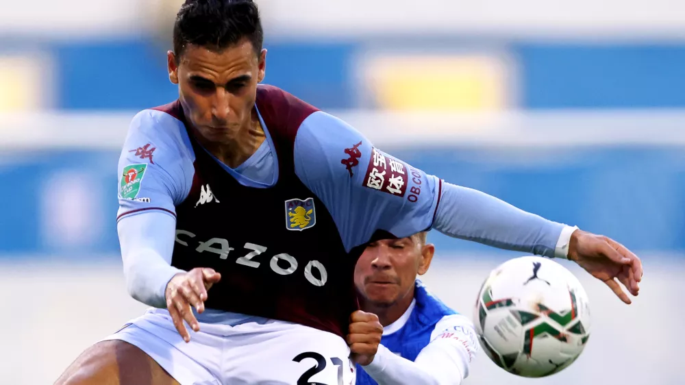 FILED - 24 August 2021, United Kingdom, Barrow-In-Furness: Then Aston Villa's Anwar El Ghazi (l) and Barrow's Connor Brown battle for the ball during the English Carabao Cup second round soccer match between Barrow and Aston Villa at Holker Street. Bundesliga football club Mainz has terminated its contract with Anwar El Ghazi following his pro-Palestinian posts on social media, the club said on Friday evening. Photo: Richard Sellers/PA Wire/dpa