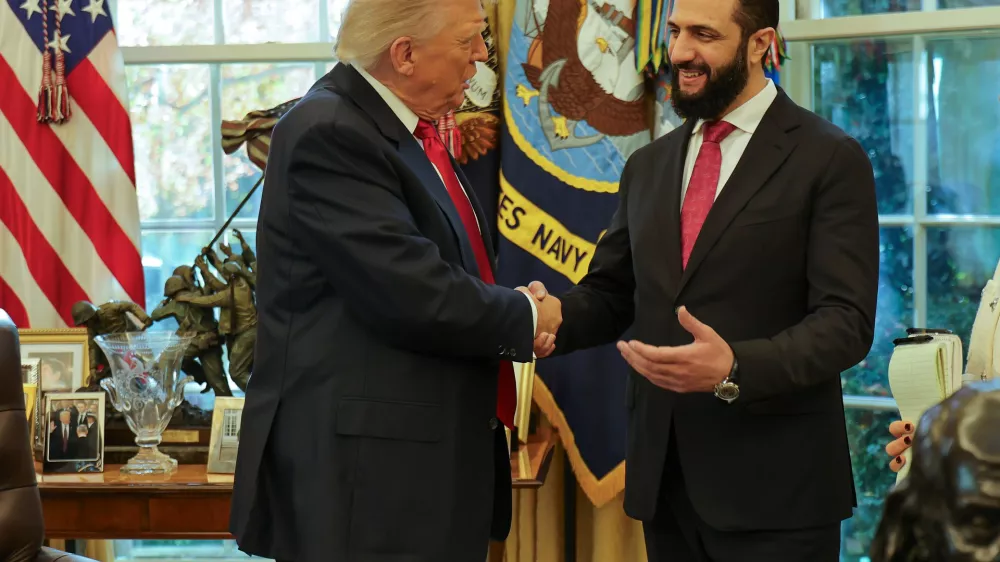 In this photo released by Syrian Presidency press office, President Donald Trump, left, shakes hands with Syria's President Ahmad al-Sharaa, at the White House in Washington, Monday, Nov. 10, 2025. (Syrian Presidency press office via AP)