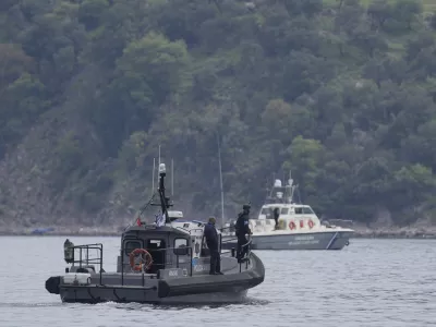 FILE- Frontex, foreground, and Greek coast guard vessels take part in a search and rescue operation, after the capsizing of a boat carrying migrants, off the coast on the northeastern Aegean Sea island of Lesbos, Greece, on April 3, 2025. (AP Photo/Panagiotis Balaskas, File)