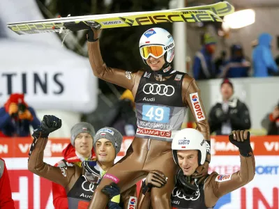 ﻿Ski Jumping - 65th four-hills ski jumping tournament final round - Bischofshofen, Austria - 06/01/2017 - Poland's Kamil Stoch celebrates among his compatriots after winning the 65th four-hills tournament.  REUTERS/Dominic Ebenbichler