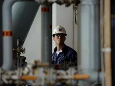 FILE PHOTO: A Chevron employee looks at oil pipes aboard Chevron's Petronius oil platform, located 100 miles (161 km) off the coast of New Orleans, in the Gulf of Mexico June 3, 2008. REUTERS/Jessica Rinaldi/File Photo