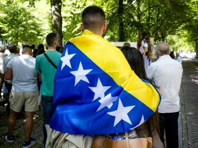 Attendees including one with a Bosnian flag take part in the National Commemoration of the Srebrenica Genocide in The Hague, on July 11, 2025. The commemoration commemorates the genocide that took place 30 years ago, of more than 8,000 Bosnian Muslim men in Srebrenica.,Image: 1021010293, License: Rights-managed, Restrictions: Netherlands OUT, Model Release: no