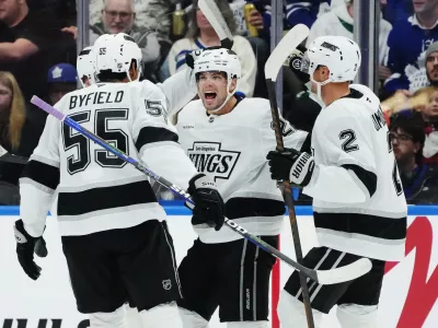 Los Angeles Kings' Kevin Fiala (second right) celebrates his goal against the Toronto Maple Leafs with Quinton Byfield (55) and Brian Dumoulin (2) during second period NHL hockey in Toronto on Thursday, Nov. 13, 2025. (Nathan Denette/The Canadian Press via AP)