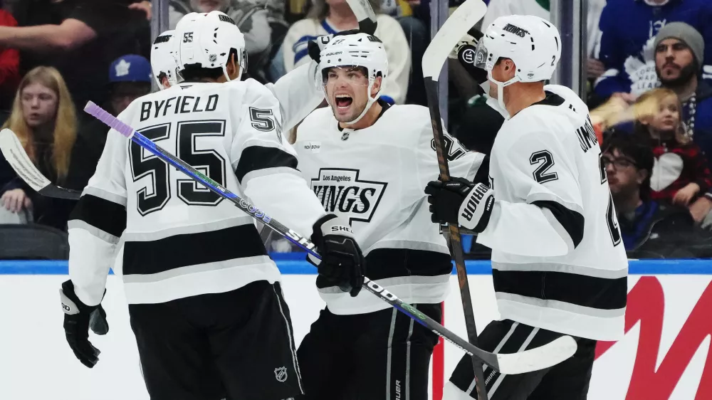 Los Angeles Kings' Kevin Fiala (second right) celebrates his goal against the Toronto Maple Leafs with Quinton Byfield (55) and Brian Dumoulin (2) during second period NHL hockey in Toronto on Thursday, Nov. 13, 2025. (Nathan Denette/The Canadian Press via AP)