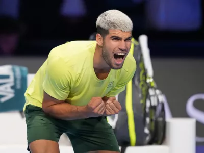 Spain's Carlos Alcaraz celebrates after winning against Italy's Lorenzo Musetti during the tennis match of the ATP World Tour Finals, in Turin, Italy, Thursday, Nov. 13, 2025. (AP Photo/Antonio Calanni)