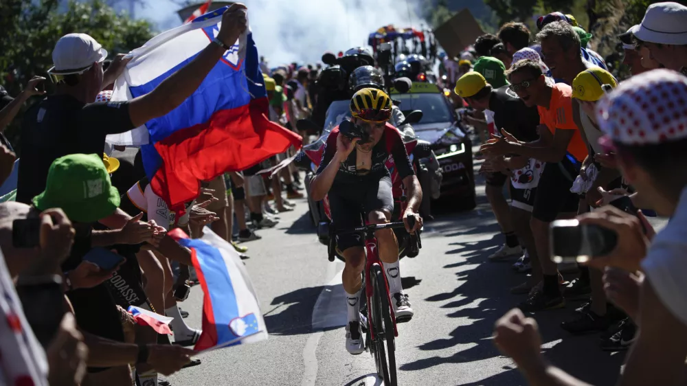 Stage winner Britain's Thomas Pidcock climbs Alpe D'Huez during the twelfth stage of the Tour de France cycling race over 165.5 kilometers (102.8 miles) with start in Briancon and finish in Alpe d'Huez, France, Thursday, July 14, 2022. (AP Photo/Daniel Cole)