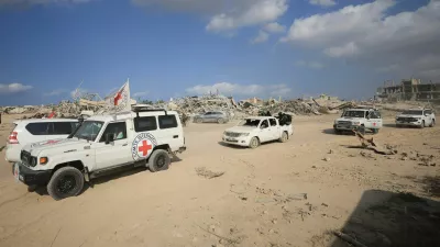 Red Cross personnel, escorted by Hamas militants, wait to head towards an area within the so-called "yellow line" to which Israeli troops withdrew under the ceasefire, as Hamas says it continues to search for the bodies of deceased hostages seized during the October 7, 2023, attack on Israel, in Gaza City November 12, 2025. REUTERS/Dawoud Abu Alkas