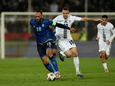Soccer Football - FIFA World Cup - UEFA Qualifiers - Group B - Kosovo v Slovenia - Fadil Vokrri Stadium, Pristina, Kosovo - October 10, 2025 Kosovo's Vedat Muriqi in action with Slovenia's Timi Elsnik REUTERS/Valdrin Xhemaj