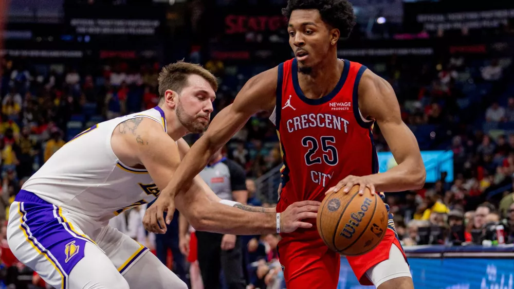Nov 14, 2025; New Orleans, Louisiana, USA; Los Angeles Lakers forward/guard Luka Dončić (77) reaches in and misses the ball against New Orleans Pelicans forward Trey Murphy III (25) during the second half at Smoothie King Center. Mandatory Credit: Stephen Lew-Imagn Images
