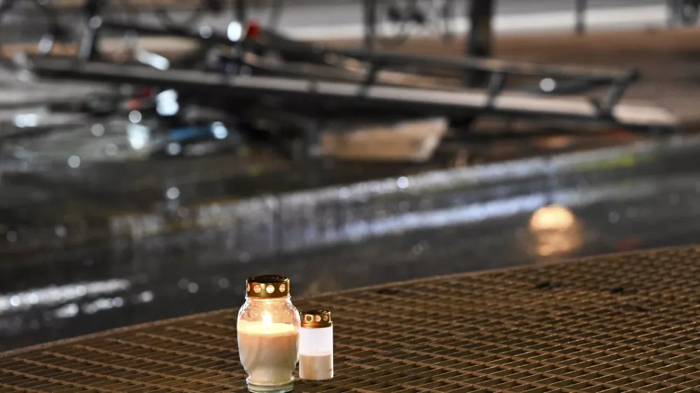 Candles for victims sit at the scene of the accident after a bus crashed into a bus stop in Östermalm in Stockholm, Sweden, Friday. Nov. 14, 2025. (Henrik Montgomery/TT News Agency via AP)