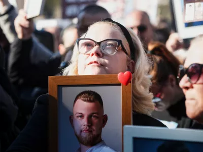 A woman holds a picture of a Kocani nightclub fire victim during a protest in Skopje, North Macedonia, on Saturday, Nov. 15, 2025, just a few days before the start of the trial for the fire. (AP Photo/Boris Grdanoski)