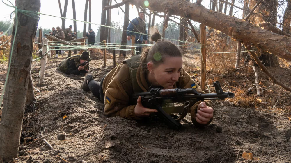 Civilians practice military skills on a training ground in Kharkiv region, Ukraine, Saturday, Nov. 15, 2025. (AP Photo/Andrii Marienko)