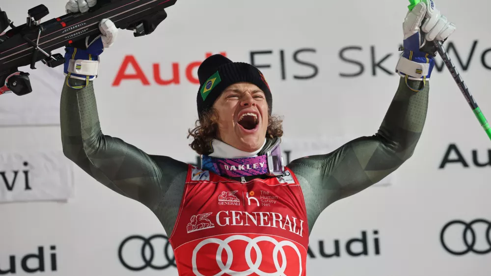 Brazil's Lucas Pinheiro Braathen celebrates on the podium winning an alpine ski, men's World Cup slalom, in Levi, Finland, Sunday, Nov. 16, 2025. (AP Photo/Marco Trovati)