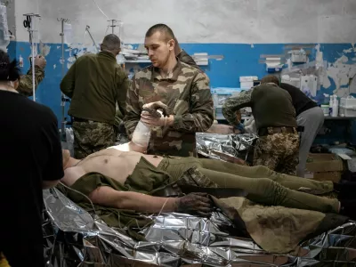 Medics treat wounded Ukrainian soldiers inside a frontline medical stabilisation point, amid Russia's attack on Ukraine, near Vuhledar, Donetsk region, Ukraine, February 19, 2023. Nearly a year into Russia's invasion, fighting now amounts to attritional duels of artillery and infantry assaults, with neither side making significant gains. The costs of that deadly grind are clear to the team of medics and nurses as it toils away, hemmed in by racks of medical supplies and portable heaters, at this stabilisation point in the Donetsk region where battles are fierce. REUTERS/Marko Djurica   SEARCH "DJURICA UKRAINE MEDICS" FOR THIS STORY. SEARCH "WIDER IMAGE" FOR ALL STORIES. TPX IMAGES OF THE DAY