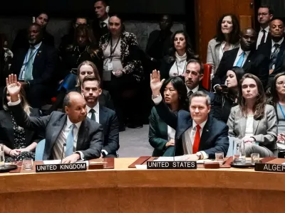 U.S Ambassador to United Nations Michael Waltz and Britain's Deputy Ambassador to the United Nations James Kariuki vote in favor for a resolution during a meeting of the United Nations Security Council to consider a U.S. proposal for a U.N. mandate to establish an international stabilization force in Gaza, at U.N. headquarters in New York City, U.S., November 17, 2025. REUTERS/Eduardo Munoz