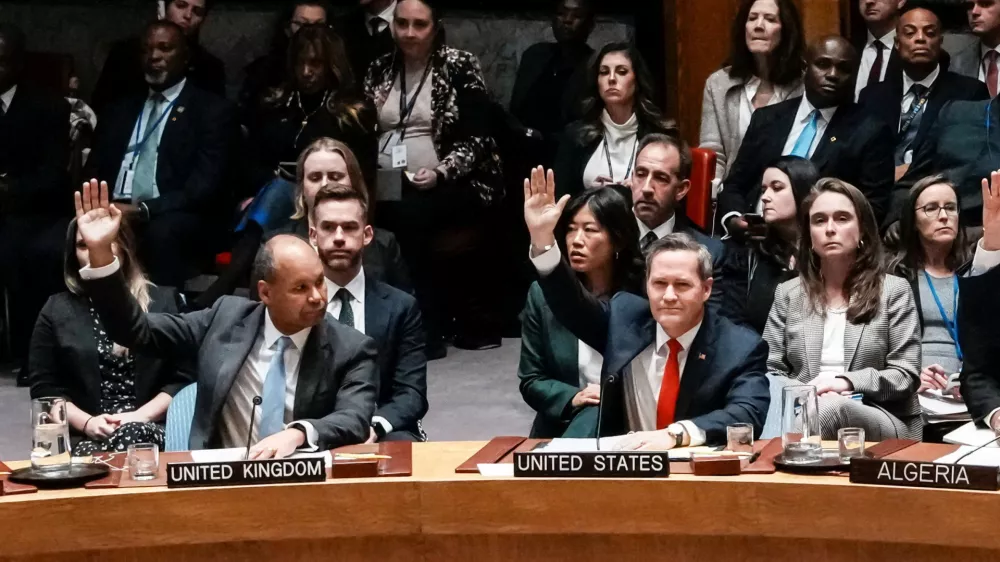 U.S Ambassador to United Nations Michael Waltz and Britain's Deputy Ambassador to the United Nations James Kariuki vote in favor for a resolution during a meeting of the United Nations Security Council to consider a U.S. proposal for a U.N. mandate to establish an international stabilization force in Gaza, at U.N. headquarters in New York City, U.S., November 17, 2025. REUTERS/Eduardo Munoz